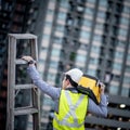 Worker man carrying aluminium ladder and tool box Royalty Free Stock Photo