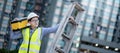 Worker man carrying aluminium ladder and tool box Royalty Free Stock Photo