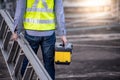 Worker man carrying aluminium ladder and tool box Royalty Free Stock Photo