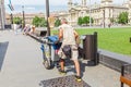 worker man cleaning garbage bins in the city