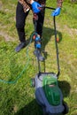 Man Cutting Green Grass With Lawn Mower In Backyard. Gardening Country Lifestyle.