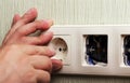 Worker man electrician is repairing damaged sockets in the apartment, installation of new closeup Royalty Free Stock Photo