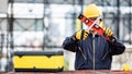 Worker man holding level tool and wrench at site Royalty Free Stock Photo