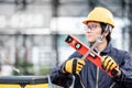 Worker man holding level tool and wrench at site Royalty Free Stock Photo