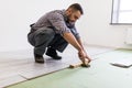 Worker Man laying laminate flooring in construction concept Royalty Free Stock Photo