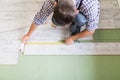 Worker Man laying laminate flooring at home room