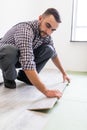 Worker Man laying laminate flooring at home room Royalty Free Stock Photo