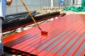 worker man paint rustproof with channels steel for building structure house roof. professional use equipment on iron surface