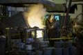 Worker man pours molten metal into molds at a steel mill