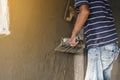 Worker man`s hand plastering a wall with trowel Royalty Free Stock Photo