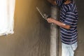 Worker man`s hand plastering a wall with trowel Royalty Free Stock Photo