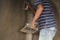 Worker man`s hand plastering a wall with trowel Royalty Free Stock Photo