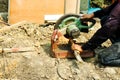 Worker man use cutting machine iron wire for building house in construction site. dirty job spin round disc wheel fast for danger Royalty Free Stock Photo