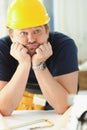 Worker man wearing architect hardhat thinking, looking bored and tired at construction site