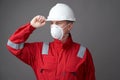 Worker man wearing hygienic mask, overall and protective hard hat Royalty Free Stock Photo