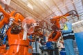 Worker man working with robot arm automate welding machine in modern metal factory. Engineer program robotic in heavy industry Royalty Free Stock Photo