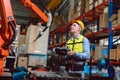 Worker man working with robot arm automate welding machine in modern metal factory. Engineer program robotic in heavy industry Royalty Free Stock Photo