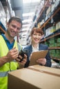 Worker and manager scanning package in warehouse Royalty Free Stock Photo