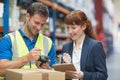 Worker and manager scanning package in warehouse Royalty Free Stock Photo