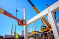 Worker is managing an elevated cherry picker at building site