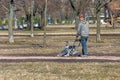 Worker with manual paver rams granite chips on a footpath in a park