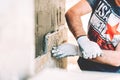 Worker mason building a house and paving with stone