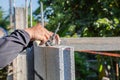 Worker masonry are building walls with cement blocks and mortar