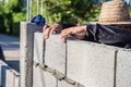 Worker masonry are building walls with cement blocks and mortar