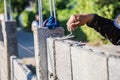 Worker masonry are building walls with cement blocks and mortar