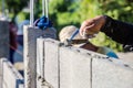 Worker masonry are building walls with cement blocks and mortar
