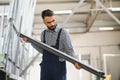 Worker measures and prepares pvc profiles in the workshop for window and door manufacturing Royalty Free Stock Photo