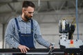 Worker measures and prepares pvc profiles in the workshop for window and door manufacturing Royalty Free Stock Photo