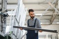 Worker measures and prepares pvc profiles in the workshop for window and door manufacturing Royalty Free Stock Photo