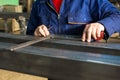 Worker measuring fresh welded steel bar