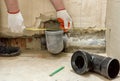 A worker is measuring the sewage drain pipe Royalty Free Stock Photo