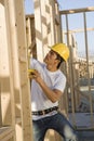 Worker Measuring Timber At Construction Site Royalty Free Stock Photo