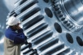 Worker, mechanic with giant gears and cogs Royalty Free Stock Photo