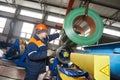 Worker at metal sheet profiling factory