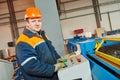 Worker at metal sheet profiling factory