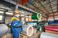 Worker at metal sheet profiling factory