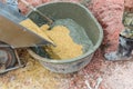 A worker mixes cement with sand directly in a pickup. Preparation of the mixture. Construction worker, sand and Cement mixed in th