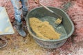 A worker mixes cement with sand directly in a pickup. Preparation of the mixture. Construction worker, sand and Cement mixed in th