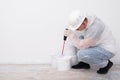 a worker mixes the paint in a bucket with a mixer on the left is a place for your inscription