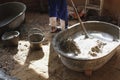 Worker mixing cement in big bucket before pouring floor Royalty Free Stock Photo