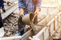 Worker mixing cement mortar plaster for construction