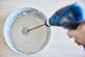 Worker mixing plaster in bucket using an electric drill Royalty Free Stock Photo