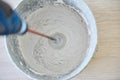 Worker mixing plaster in bucket using an electric drill Royalty Free Stock Photo