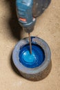 Worker are mixing up old blue paint with drill Royalty Free Stock Photo