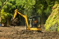 A Worker on modern excavator performs excavation work on the construction site, a Park in Keputih Surabaya. Royalty Free Stock Photo