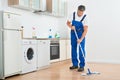 Worker Mopping Floor In Kitchen At Home Royalty Free Stock Photo
